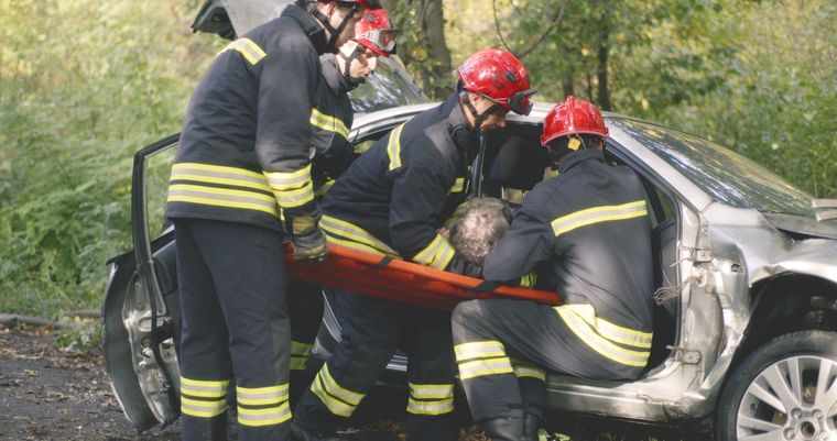 Firefighters extracting a driver from a wrecked vehicle